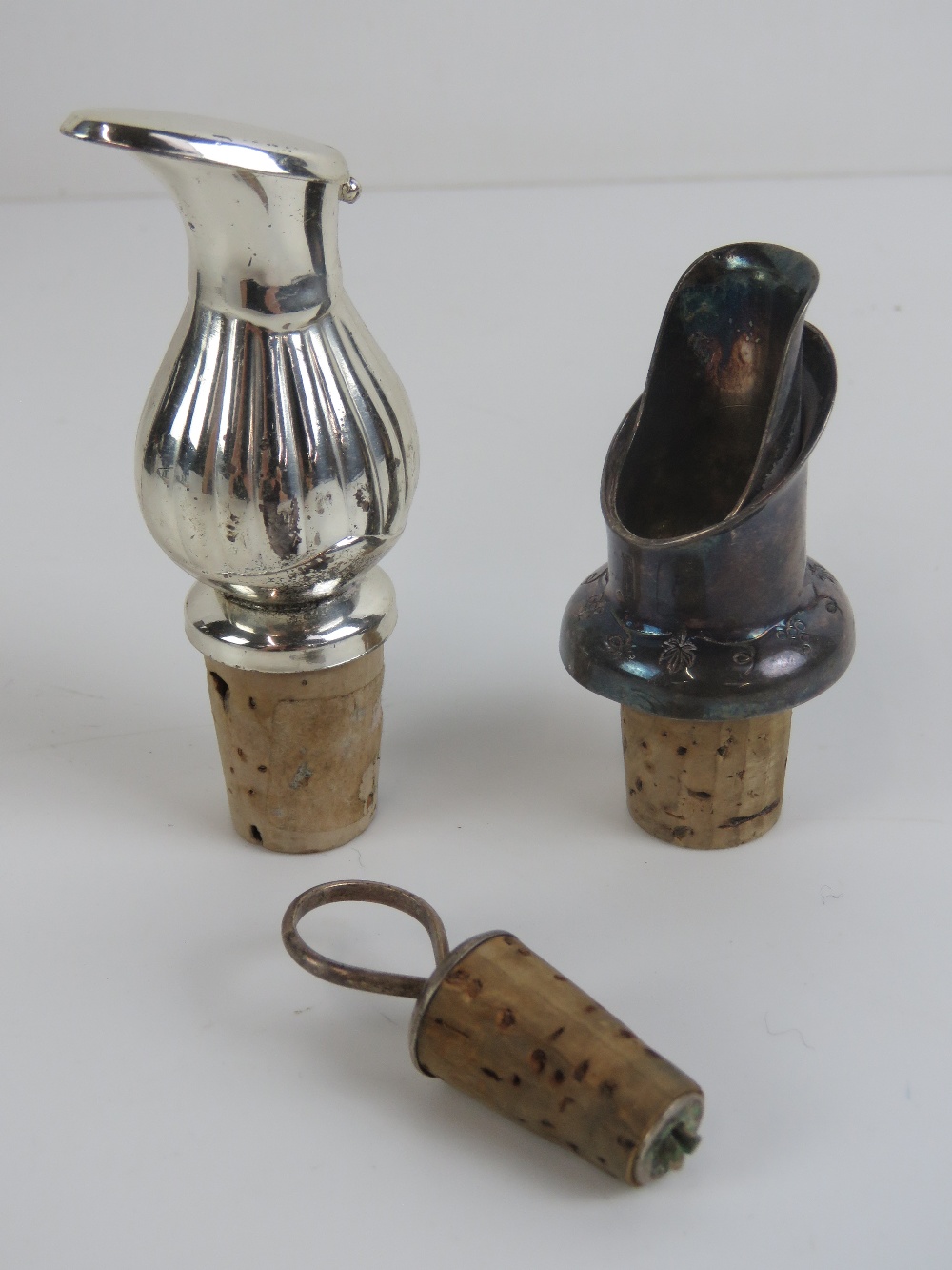 A small carafe cork and silver plated and stopper together with two wine pouring spouts.