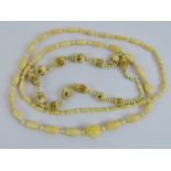 A late Victorian carved ivory bead long necklace, having hidden screw clasp, 94cm in length.