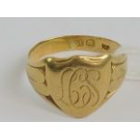 An 18ct gold signet ring with shield head engraved with 'LCS' monogram, worn 18ct gold hallmark,