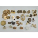 A quantity of oddments including cap badges, cufflinks, chains, beads, etc.