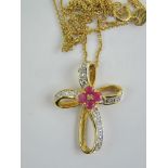 A gold on silver cross pendant and chain, cross measuring 2.4cm in length.