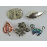 Four silver brooches being an abstract leaf, a maple leaf, a cat and a marcasite set flower.