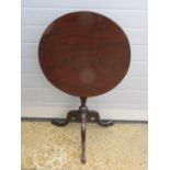 A 19th century mahogany tilt-top table raised upon short stem over three outswept feet,