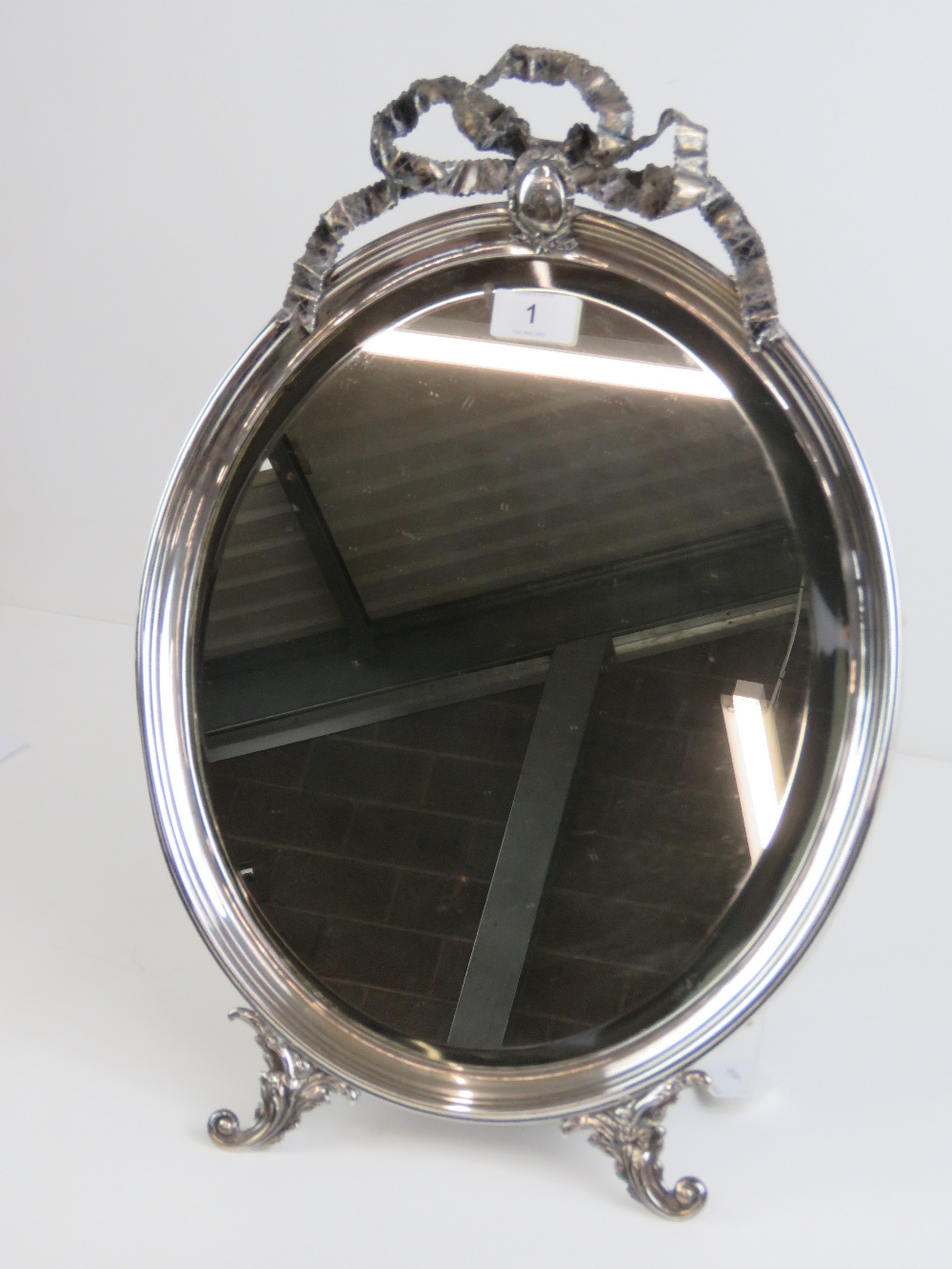 An impressive HM silver (hallmarks worn) freestanding oval easel table mirror having bevelled edge