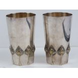 A pair of WMF silver plated Art Nouveau beakers having leaf pattern border and gilded interior,