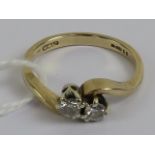 A 9ct gold diamond ring having twin round cut brilliant diamonds in twist setting, total 0.