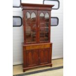 A mahogany two sectional bookcase on base, the base comprising single drawer with twin doors under,