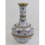 A delightful oriental export famille rose baluster vase, part gilded and decorated throughout.