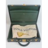 A green leather covered Louis Vuitton briefcase bearing LV to the locks,