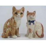 Two seated pottery cats, one with glass eyes in the style of Winstanley 22cm high, a/f.