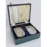 A cased HM silver dressing set comprising pair of brushes and comb (some teeth deficient),