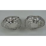A pair of HM silver heart shaped bonbon dishes having pierced and repoussé decoration throughout,