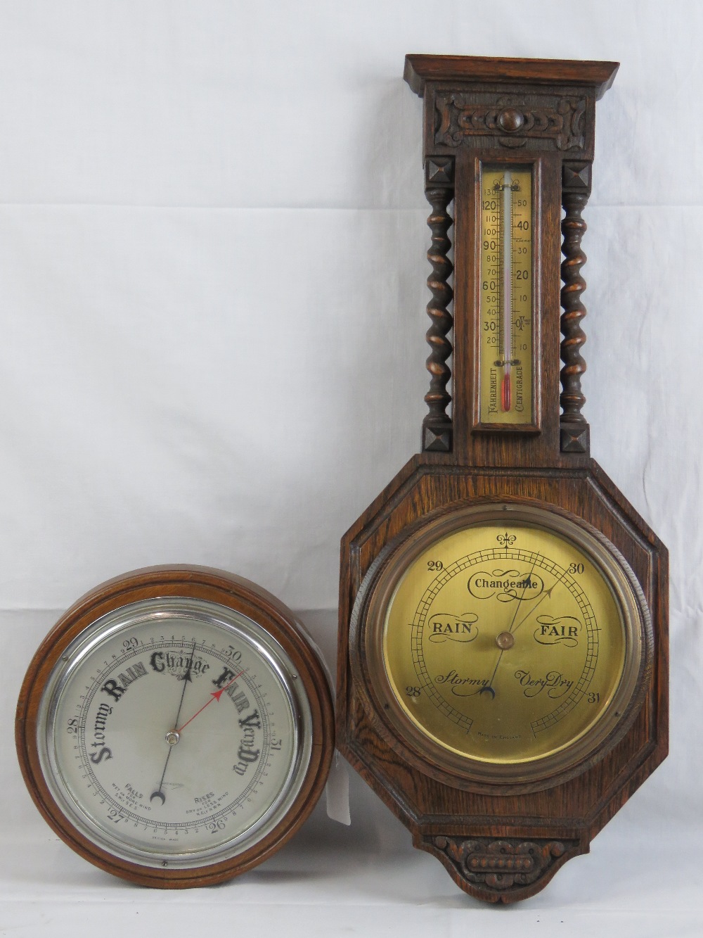 A compensated circular aneroid barometer in mahogany frame, 22cm dia,