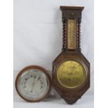 A compensated circular aneroid barometer in mahogany frame, 22cm dia,