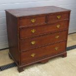 A good late Georgian chest of two short over three long drawers in oak, raised over bracket feet,