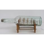 A Classic ship in bottle on wooden base.