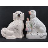 Two Staffordshire Spaniel dog figurines, 33cm and 34cm high respectively.