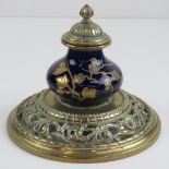 A fine continental circular pierced brass inkwell having cobalt blue ceramic reservoir with gilded