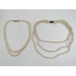A triple strand faux pearl necklace and a double strand faux pearl necklace,