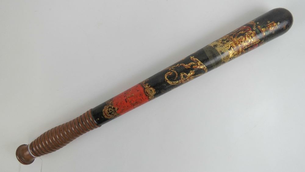 A Victorian truncheon having black ground painted crown with VR cypher, beehive handle,
