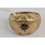 A 9ct gold gypsy ring with round cut garnet in star setting, hallmarked 375, size R, 7.2g.