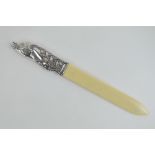 A white metal and ivory page turner the handle in the form of a horses head in bridle,