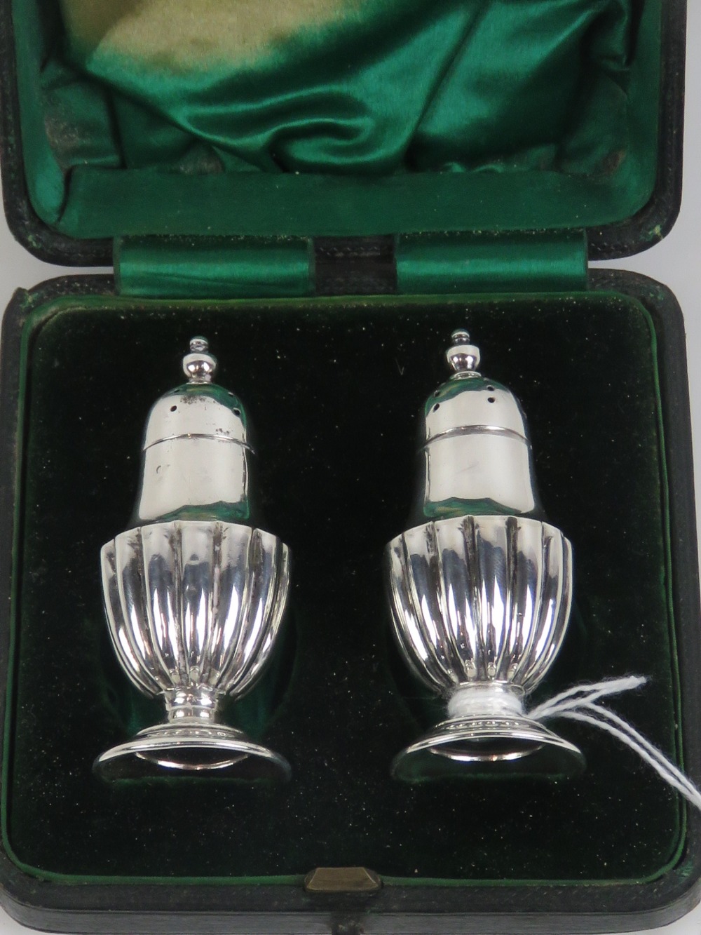 A pair of miniature HM silver pepperettes having gadrooned bodies and standing 6.