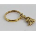 A 22ct gold D-band ring having 9ct gold elf or imp charm upon, hallmarked London, size N, 4.3g.