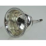 A George IV HM silver wine funnel having wave pattern rim and clam shell hanger, approx 15.