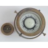 A gimble mounted brass cases maritime compass having 4" dial,