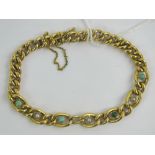A vintage 9ct gold bracelet set with four turquoise cabachons and three seed pearls,