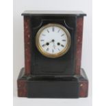 A mid 19th century polished slate eight day striking mantle clock, 33cm high,