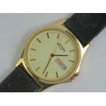 A gold plated Rotary wristwatch with cream dial, day and date aperture, 36mm dia case.