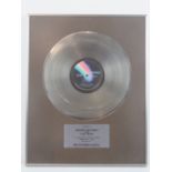 An original 1973 12" platinum disc 'Presented to Roger Daltrey and The Who for outstanding record