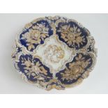 A 19th century Meissen relief bowl having cobalt blue panels and gilded throughout,