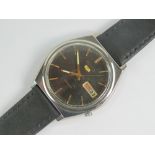 A Seiko 5 automatic wristwatch with black dial, yellow metal hands and batons,
