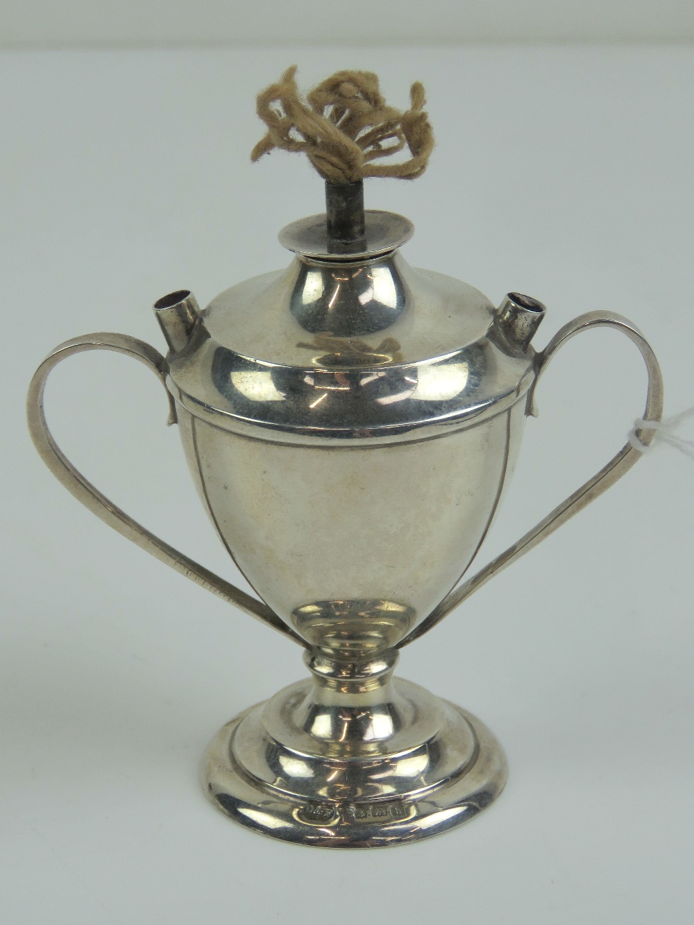 A miniature HM silver oil lamp having twin handles and standing 7.