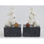 A pair of marble based bookends surmounted by novelty Terrier dogs, each standing 16cm high.