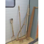 A small quantity of assorted long handled garden tools including; fork, hoe, pitchfork, scythe,