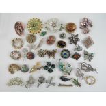 A quantity of assorted costume jewellery brooches including; Austrian made flower,