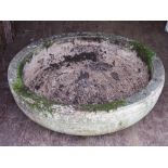 A large circular garden planter / birdbath in composite stone and having early English style