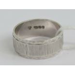 A HM silver ring having triangular patterned border and bark effect central panel,