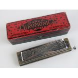 A boxed Horner super chromonica chromatic harmonica.