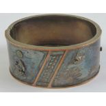 A delightful white metal hinged cuff bangle having engraved sunset scene upon with applied bird and