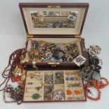 A quantity of assorted costume and white metal jewellery within a contemporary jewellery box.