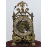 A delightful twin fusee skeleton clock having steel chapter ring with Roman numerals,