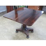 A rosewood slide and tilt top fold over tea table raised over tapering octagonal stem on quatro