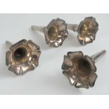 Four silver plated eperne floral spill flutes, each measuring 12cm in length.