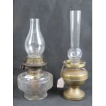 Two Victorian oil lamps; one glass and one brass.