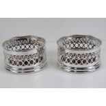 A fine pair of silver plated wine coasters each having wooden base and measuring 11cm dia.